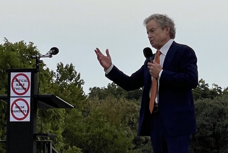 Republican candidate for Texas Governor Don Huffines holds a microphone and gestures as he addresses a gathering in Dallas.
