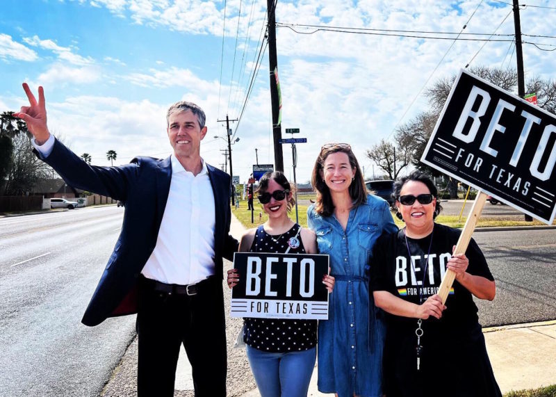 Beto O'Rourke gestures to passing cars as he gets out the vote with his wife Amy and two supporters in Mission, Texas